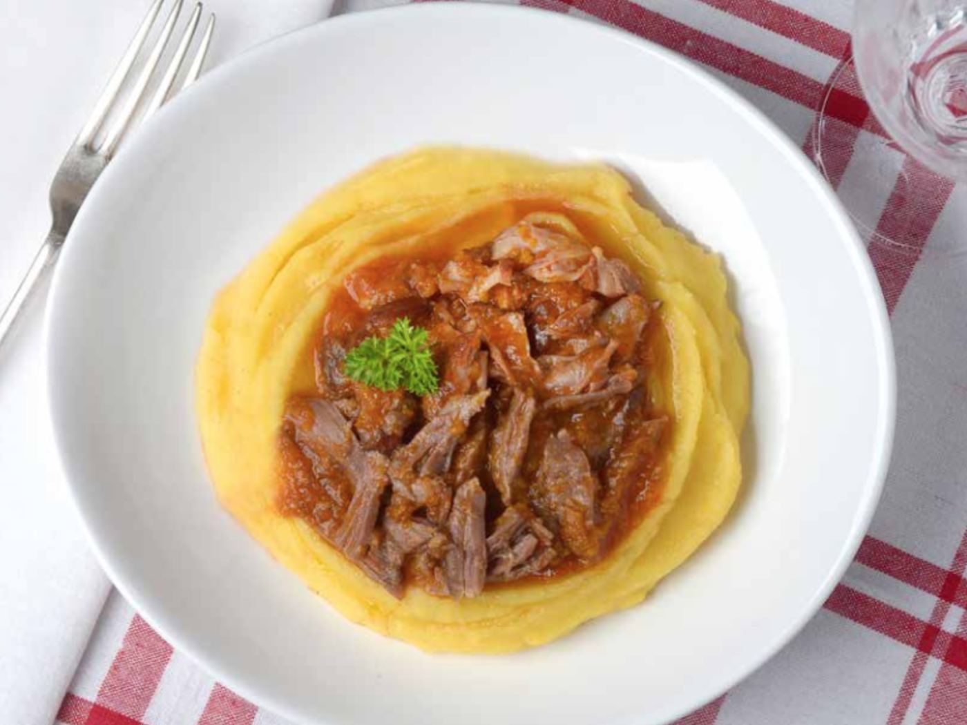 Ragu de costela sobre polenta cremosa